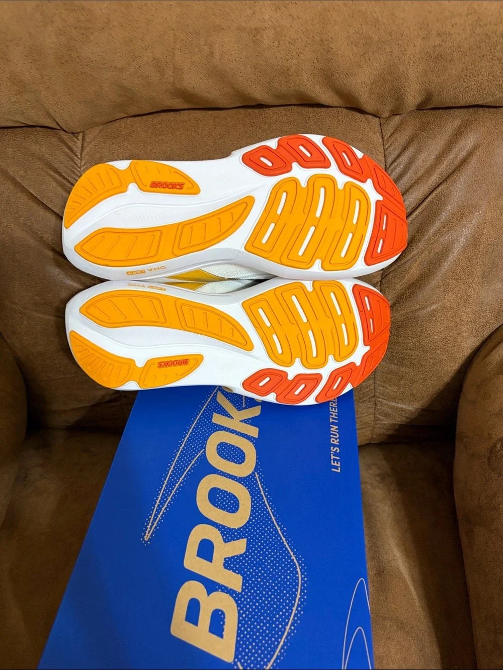 Brooks Revel 9 Men’s Running Shoe in White with Black, Yellow & Orange Accents